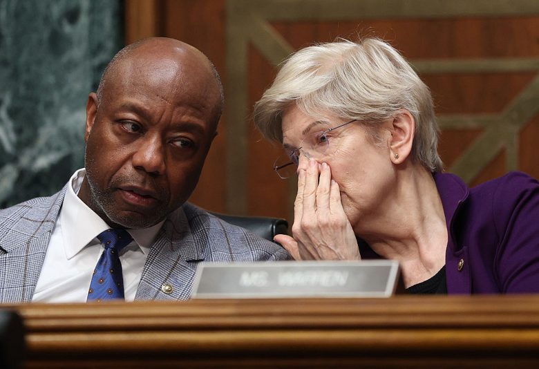 WASHINGTON, DC - FEBRUARY 05: Chair of the Senate Committee on Banking, Housing, and Urban Affairs Sen. Tim Scott (R-SC) talks to Ranking Member Sen. Elizabeth Warren (D-MA) as U.S. Treasury Secretary Scott Bessent testifies before the committee in the Dirksen Senate Office Building on February 05, 2026 in Washington, DC. The Committee met to hear testimony on the Financial Stability Oversight Council’s Annual Report to Congress. (Photo by Kevin Dietsch/Getty Images)