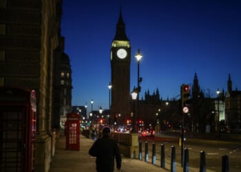 A pedestrian walks down the street toward Big Ben and the Houses of Parliament in Westminster in central London, early morning on Nov. 26, 2025, ahead of the government's budget presentation.