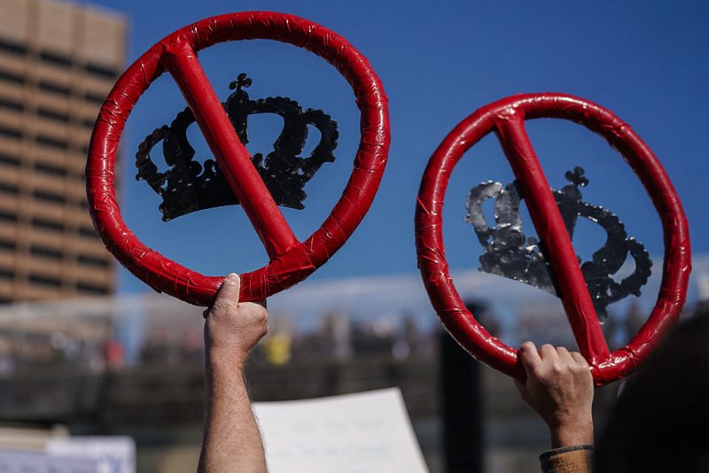 People hold up images of crowns with red lines through them during the "No Kings" national day of protest in Atlanta, Georgia, on March 28, 2026. Nationwide protests against US President Donald Trump are expected Saturday as millions of people vent fury over what they see as his authoritarian bent and other forms of cruel, law-trampling governance. It is the third time in less than a year that Americans will take to the streets as part of a grassroots movement called "No Kings," the most vocal and visual conduit for opposition to Trump since he began his second term in January 2025. (Photo by Elijah Nouvelage / AFP via Getty Images)