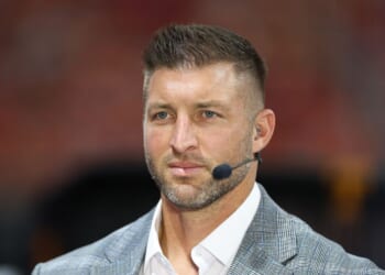 Tim Tebow sits on the set of SEC Network prior to the 2025 Aflac Kickoff Game between the Syracuse Orange and the Tennessee Volunteers at Mercedes-Benz Stadium on Aug. 30, 2025, in Atlanta, Georgia.