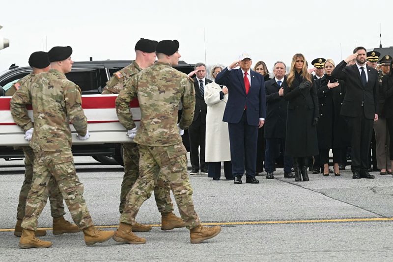 (L/R) White House chief of staff Susie Wiles, US President Donald Trump, special envoy Steve Witkoff, First Lady Melania Trump and Attorney General Pam Bondi lookon as members of a US Army team carry a flagged-drapped transfer case containing the remains of one of six US soldiers during a dignified transfer solemn event at Dover Air Force Base, in Dover, Delaware, on March 7, 2026. Six US Army soldiers were killed March 1 when an Iranian drone struck a key US command center in Kuwait's southern industrial hub of Port Shuaiba, a day after the United States and Israel launched a sweeping military campaign against Iran. (Photo by SAUL LOEB / AFP via Getty Images)
