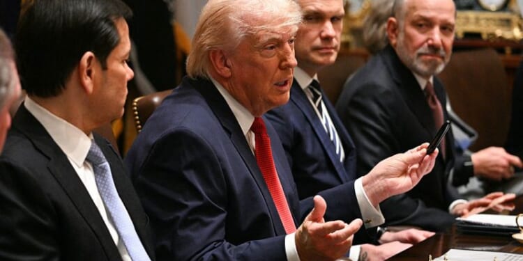 US President Donald Trump speaks, flanked by Secretary of State Marco Rubio (L), Defense Secretary Pete Hegseth (2nd R) and Commerce Secretary Howard Lutnick (R), during a cabinet meeting in the Cabinet Room of the White House in Washington, DC, on March 26, 2026. (Photo by Jim WATSON / AFP via Getty Images)