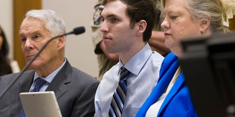PROVO, UTAH - JANUARY 16: Tyler Robinson, center, accused in the fatal shooting of Charlie Kirk, appears during a hearing in 4th District Court on January 16, 2026 in Provo, Utah. Prosecutors have charged Tyler Robinson with aggravated murder and plan to seek the death penalty. (Photo by Bethany Baker-Pool/Getty Images)