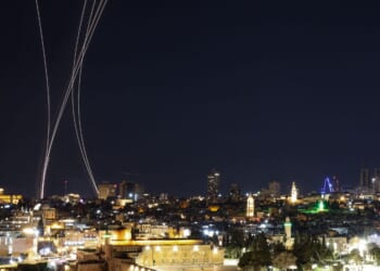 Rocket trails from an interception by Israel's Iron Dome missile defense system are pictured over Jerusalem on March 1, 2026.