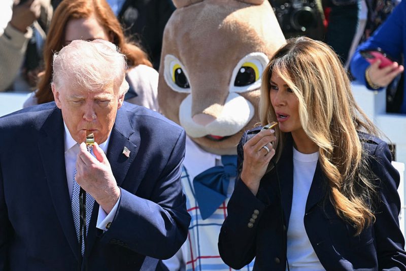 US President Donald Trump and First Lady Melania Trump blow whistles as children participate in the annual Easter Egg Roll on the South Lawn of the White House on April 6, 2026, in Washington, DC. (Photo by SAUL LOEB / AFP via Getty Images)
