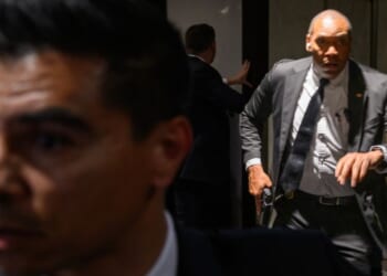 Agents draw their guns at the White House Corresondents' dinner at the Washington Hilton in Washington, DC after shots are fired on April 25, 2026.