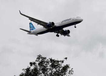A JetBlue plane lands at Los Angeles International Airport on March 31, 2026 in Los Angeles, California.