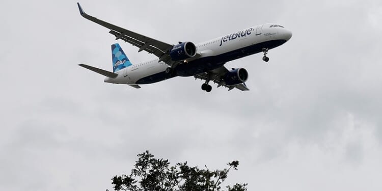 A JetBlue plane lands at Los Angeles International Airport on March 31, 2026 in Los Angeles, California.