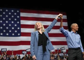 Former President Barack Obama and Virginia Gov. Abigail Spanberger, raise their arms together during a campaign rally in the Chartway Arena on Nov. 1, 2025, in Norfolk, Virginia.