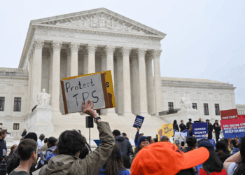 Members of the National TPS Alliance rally at the US Supreme Court in Washington, DC, on April 29, 2026. The Supreme Court is examining the revocation of Temporary Protected Status (TPS) for Haitian and Syrian migrants. (Photo by Alex WROBLEWSKI / AFP via Getty Images)