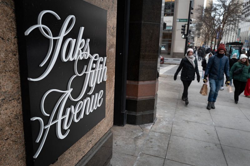 CHICAGO, ILLINOIS - DECEMBER 30: Pedestrians walk past a Saks Fifth Avenue store on December 30, 2025 in Chicago, Illinois. Recent reports indicate that Saks Global Enterprises, the parent corporation of Saks Fifth Avenue, may file for Chapter 11 bankruptcy as they face a more than $100 million debt payment due at the end of December. (Photo by Scott Olson/Getty Images)