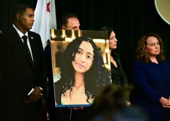 A portrait of the late Celeste Rivas Hernandez is shown during a press briefing by Los Angeles County District Attorney Nathan J. Hochman (out of frame) on the case against singer D4vd in Los Angeles, on April 20, 2026. Singer D4vd was charged April 20 with the murder and dismemberment of his young teenage girlfriend, whose decomposing corpse was found in a Tesla that had been abandoned in the Hollywood Hills. The 21-year-old, whose real name is David Anthony Burke, was expected to appear in court Monday to face multiple charges over the horrifying death of Celeste Rivas Hernandez, whose body was discovered in September, within days of what would have been her 15th birthday. (Photo by Frederic J. BROWN / AFP via Getty Images)