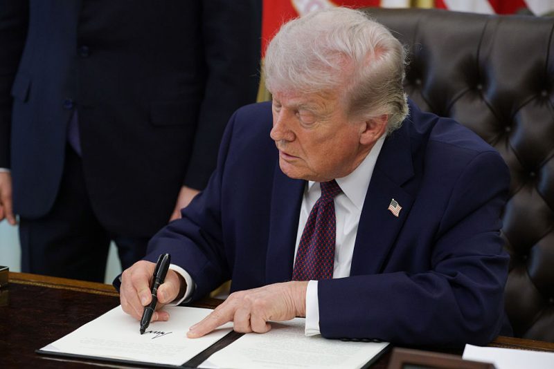 WASHINGTON, DC - MARCH 31: U.S. President Donald Trump signs an executive order to limit mail-in voting in the Oval Office of the White House on March 31, 2026 in Washington, DC. President Trump has sought to restrict mail-in voting after claiming the 2020 election was stolen from him due to fraud. (Photo by Alex Wong/Getty Images)