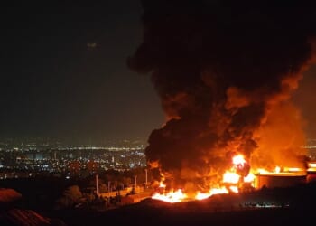 TEHRAN, IRAN - JUNE 15: Fire and smoke rise into the sky after an Israeli attack on the Shahran oil depot on June 15, 2025 in Tehran, Iran. Iran
