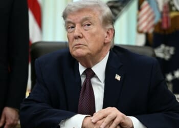 President Donald Trump sits at the Resolute Desk in the Oval Office on March 31, 2026.